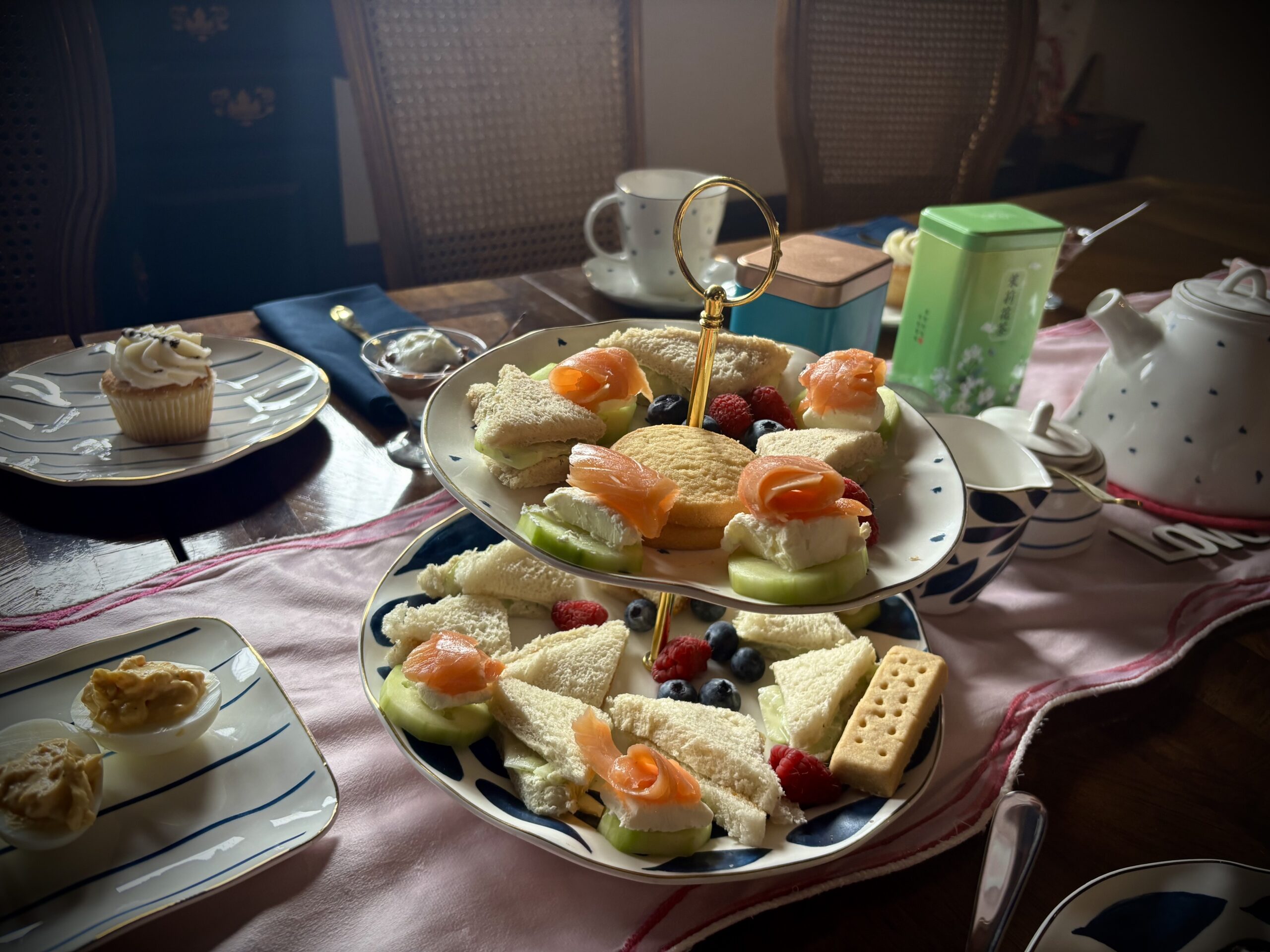 Tiered high tea tray with finger sandwiches, smoked salmon, berries, and sweets in the Fears House dining room